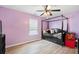 Bedroom with lavender walls and wood-look floors featuring a bed, a window, and natural light at 2106 Clipstone Dr, Ladson, SC 29456