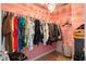 Walk-in closet with vibrant pink walls featuring an ample supply of clothing and accessories at 2106 Clipstone Dr, Ladson, SC 29456