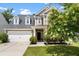 Charming two-story home with a well-manicured lawn and a two car garage at 2106 Clipstone Dr, Ladson, SC 29456