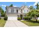 Charming two-story home with a well-manicured lawn and a two car garage at 2106 Clipstone Dr, Ladson, SC 29456