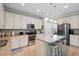 Modern kitchen featuring an island with stool seating, granite countertops and stainless steel appliances at 2106 Clipstone Dr, Ladson, SC 29456