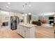 Open kitchen with stainless steel appliances and granite countertops flows into the adjacent living area at 2106 Clipstone Dr, Ladson, SC 29456