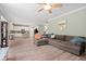 Inviting living room featuring wood floors, a ceiling fan and seamless access to the kitchen at 2106 Clipstone Dr, Ladson, SC 29456