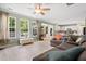 Open-concept living room boasts wood floors, large windows, and a smooth transition to the kitchen at 2106 Clipstone Dr, Ladson, SC 29456