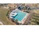 Aerial view of a community pool featuring multiple lanes, palm trees, and a covered seating area at 2106 Clipstone Dr, Ladson, SC 29456