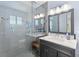Modern bathroom with a walk-in shower, glass enclosure, updated lighting, and a sleek gray vanity at 216 Freeman St, Mount Pleasant, SC 29464