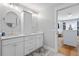 Elegant bathroom showcasing dual sinks, ample storage, modern fixtures, and an open doorway to the walk-in closet at 216 Freeman St, Mount Pleasant, SC 29464