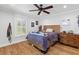 Cozy bedroom with hardwood floors, a ceiling fan, a window with shutters, and plenty of natural light at 216 Freeman St, Mount Pleasant, SC 29464
