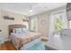 Bright bedroom featuring a woven headboard, ceiling fan, and bright natural light from two windows at 216 Freeman St, Mount Pleasant, SC 29464