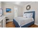 Bedroom featuring a large window, comfortable bed with a blue frame, and hardwood floors at 216 Freeman St, Mount Pleasant, SC 29464