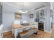 Elegant dining area with custom cabinets, beverage cooler, and unique wood table at 216 Freeman St, Mount Pleasant, SC 29464