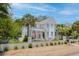 Charming two-story home with a brick wall, front porch, and an American flag at 216 Freeman St, Mount Pleasant, SC 29464