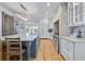 Bright kitchen featuring a marble island, brick accent wall, stainless steel appliances, and hardwood floors at 216 Freeman St, Mount Pleasant, SC 29464