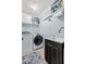 Functional laundry room with modern washer and dryer, utility sink, and ample storage shelving at 216 Freeman St, Mount Pleasant, SC 29464