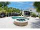 Backyard pool and spa with brick pavers, palm trees, and lounge seating, ideal for relaxation and recreation at 216 Freeman St, Mount Pleasant, SC 29464