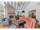 Inviting sunroom with brick fireplace, stylish furnishings, and outdoor cooking area, perfect for relaxing and entertaining at 216 Freeman St, Mount Pleasant, SC 29464