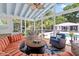 Bright sunroom boasts a fireplace, cozy seating, ceiling fan, and views of the pool and backyard at 216 Freeman St, Mount Pleasant, SC 29464