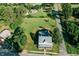 An aerial view showcasing the property with a large backyard and the surrounding neighborhood's tree-lined streets at 21877 Lowcountry Hwy, Ruffin, SC 29475
