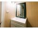 Bathroom features modern vanity with decorative mirror and wood paneling at 21877 Lowcountry Hwy, Ruffin, SC 29475