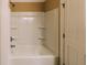 Bright bathroom featuring a shower and tub combination with recessed shelving for storage at 21877 Lowcountry Hwy, Ruffin, SC 29475