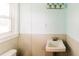 Bathroom featuring a charming sink, wainscotting, and natural light from the window at 21877 Lowcountry Hwy, Ruffin, SC 29475
