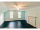 Spacious bedroom with two windows, ceiling fan, light blue walls, and fireplace mantle at 21877 Lowcountry Hwy, Ruffin, SC 29475