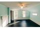 Bedroom featuring blue walls, dark floors, two windows, a ceiling fan, and fireplace at 21877 Lowcountry Hwy, Ruffin, SC 29475