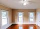 Bedroom features hardwood floors, a ceiling fan, and large windows that provide plenty of natural light at 21877 Lowcountry Hwy, Ruffin, SC 29475
