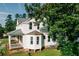 Angle view of a beautiful home showing the windows, porch, a bit of yard and tree branches at 21877 Lowcountry Hwy, Ruffin, SC 29475