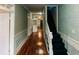 Hallway featuring wood floors and a staircase, leading to other rooms of the home at 21877 Lowcountry Hwy, Ruffin, SC 29475