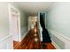 Inviting hallway featuring wood floors, staircase, and soft, light-colored walls at 21877 Lowcountry Hwy, Ruffin, SC 29475