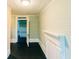 Hallway with light green walls and dark hardwood floors leading to additional rooms at 21877 Lowcountry Hwy, Ruffin, SC 29475
