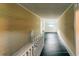 Hallway with dark hardwood floors and classic white railings at 21877 Lowcountry Hwy, Ruffin, SC 29475