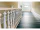 Hallway with wood floors and classic white railings at 21877 Lowcountry Hwy, Ruffin, SC 29475