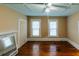 Cozy living room with hardwood floors, a ceiling fan, and large windows at 21877 Lowcountry Hwy, Ruffin, SC 29475