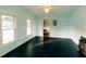 Bright living room with blue walls, black floors, and large windows letting in ample natural light at 21877 Lowcountry Hwy, Ruffin, SC 29475