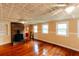 Living room showcasing a brick fireplace, hardwood floors, and natural light at 21877 Lowcountry Hwy, Ruffin, SC 29475