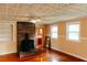 Living room showcasing a brick fireplace, hardwood floors, and views to the kitchen at 21877 Lowcountry Hwy, Ruffin, SC 29475