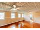 Living room with original ceiling, hardwood floors, and views to the bathroom at 21877 Lowcountry Hwy, Ruffin, SC 29475