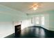 Cozy living room with a fireplace, bay windows, and beautiful dark hardwood floors at 21877 Lowcountry Hwy, Ruffin, SC 29475