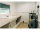 Practical utility room featuring a sink, storage, and water heater at 21877 Lowcountry Hwy, Ruffin, SC 29475