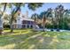 Expansive backyard with lush lawn, mature trees, a pool and outdoor furniture at 2414 Goldbug Ave, Sullivans Island, SC 29482