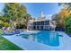 Gorgeous backyard showcasing a pristine pool, lounge chairs, and lush greenery, perfect for relaxation at 2414 Goldbug Ave, Sullivans Island, SC 29482