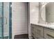 Modern bathroom featuring gray vanity, unique tile in shower, and ship lap style walls at 2414 Goldbug Ave, Sullivans Island, SC 29482