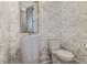 Elegant powder room with marble wallpaper, modern toilet and pedestal sink at 2414 Goldbug Ave, Sullivans Island, SC 29482