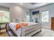 Bright bedroom featuring a white four-poster bed, and hardwood floors at 2414 Goldbug Ave, Sullivans Island, SC 29482