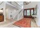 Grand foyer featuring a staircase, chandelier, and elegant wood flooring at 2414 Goldbug Ave, Sullivans Island, SC 29482