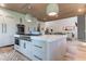 Gourmet kitchen featuring a large island, high-end appliances, and an open layout to the living area at 2414 Goldbug Ave, Sullivans Island, SC 29482