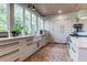Bright kitchen with stainless appliances, large windows and a farmhouse sink with a view at 2414 Goldbug Ave, Sullivans Island, SC 29482