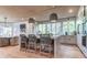 Modern kitchen boasting an island with seating, stainless steel appliances, and lots of natural light at 2414 Goldbug Ave, Sullivans Island, SC 29482